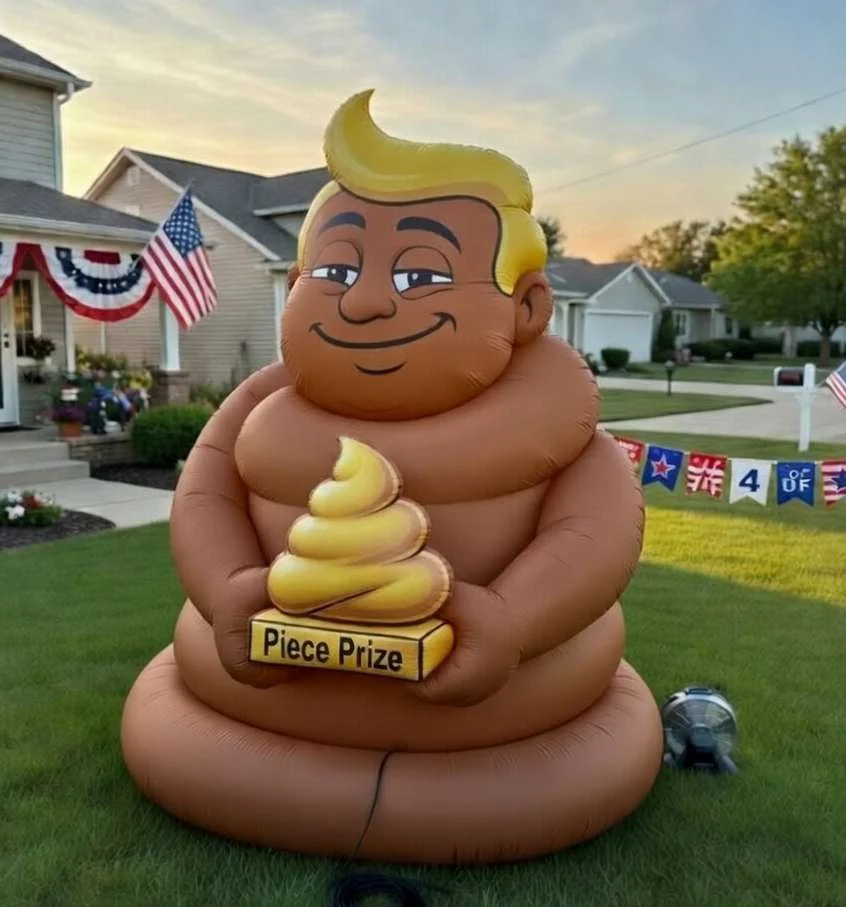 Smiling turd-Trump inflatable in a suburban yard on July 4th holding a 'Piece Prize' trophy