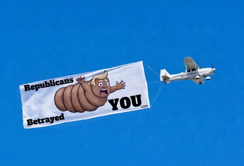 Airplane towing aerial banner: 'Republicans Betrayed YOU' with turd-Trump character